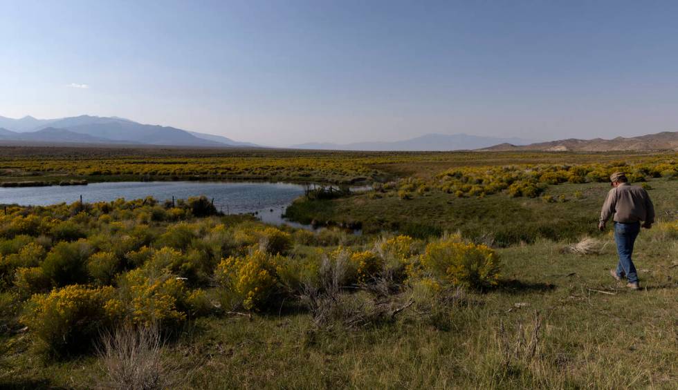 Rancher Tom Baker walks around a pond on his ranch on Friday, Sept. 9, 2022, in Garrison, Utah. ...