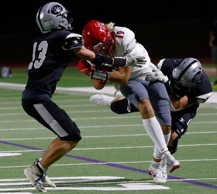 Arbor View’s Jackson Carpenter (19) is tackled by Palo Verde’s Tommy Gardner (13) and Samu ...