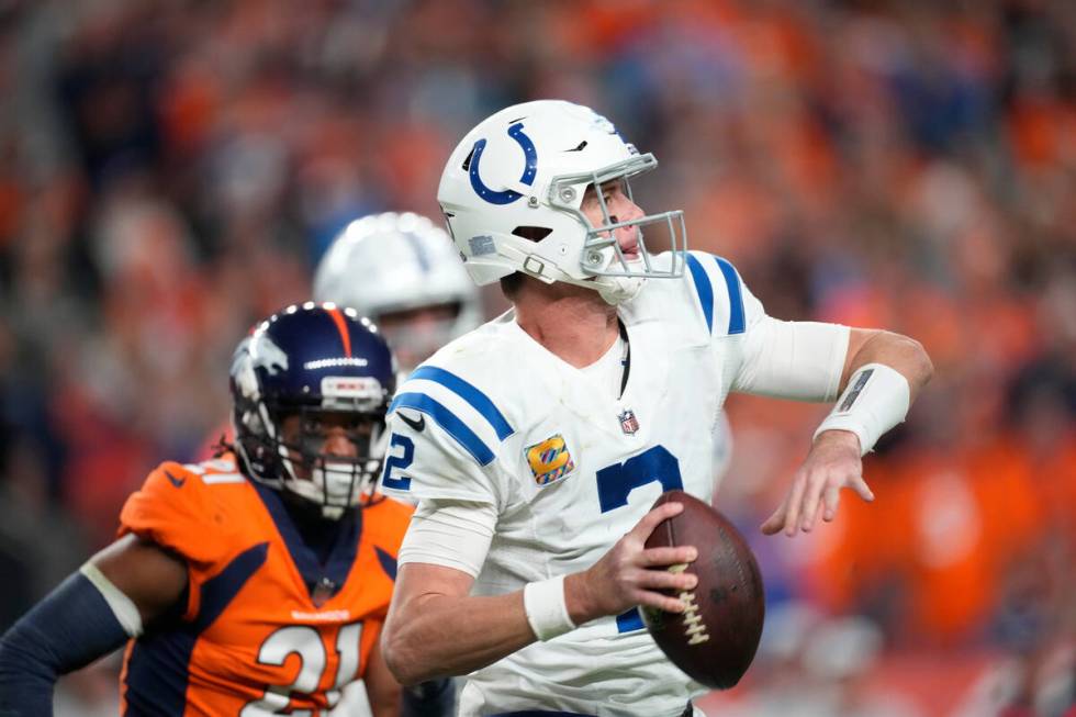 Indianapolis Colts quarterback Matt Ryan (2) is pursued by Denver Broncos cornerback K'Waun Wil ...