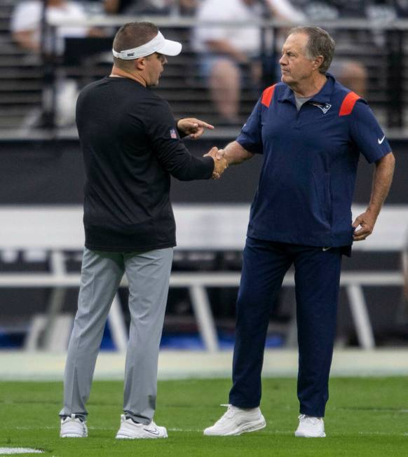 Raiders head coach Josh McDaniels and New England Patriots head coach Bill Belichick shake hand ...