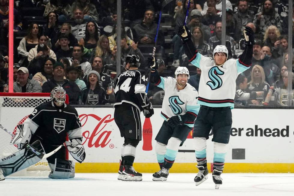 Seattle Kraken left wing Brandon Tanev, right, celebrates his goal with right wing Jordan Eberl ...