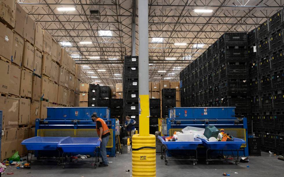 Employees sort items at the Goodwill Distribution Center on Friday, Oct. 14, 2022, in Las Vegas ...