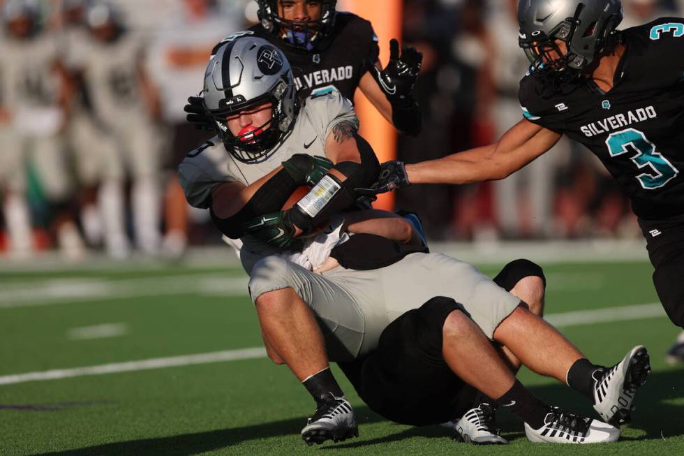 Silverado's Brandon Trang (24) tackles Palo Verde's Blair Thayer (23) during the first half of ...