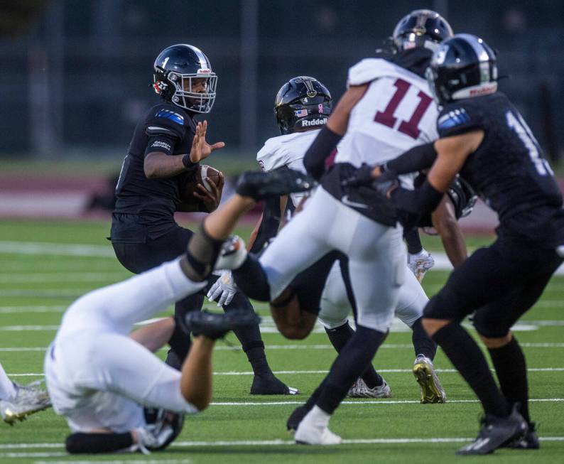 Desert Pines QB Marquis Roby (1) scrambles for a few more yards versus Faith Lutheran's defense ...