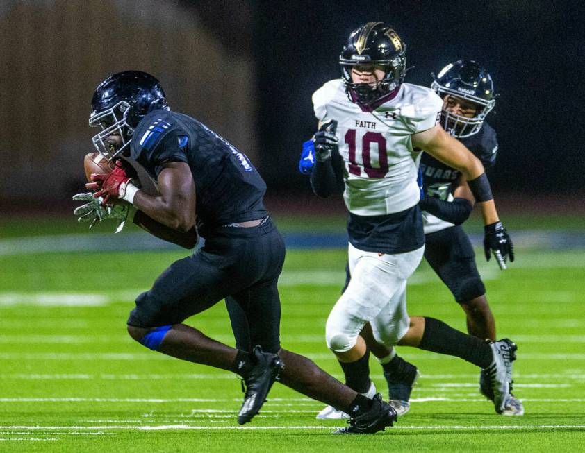 Desert Pines OLB Kenneth Goodwin (18) intercepts a pass over Faith Lutheran's WR Peyton Steiger ...