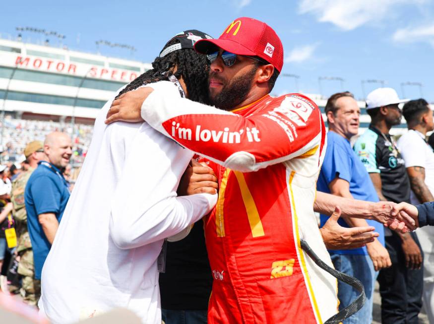 Honorary pace car driver Davante Adams of the Raiders, left, greets driver Bubba Wallace before ...