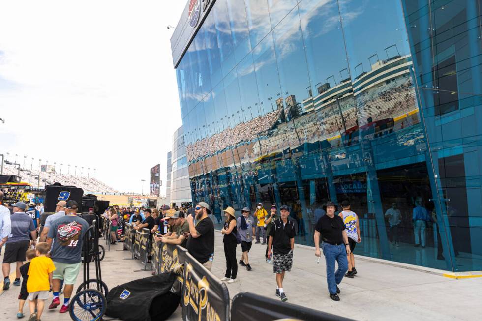 People walk around pit road before the NASCAR Cup Series playoff race at Las Vegas Motor Speedw ...