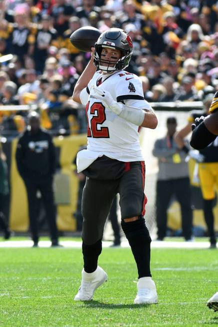 Tampa Bay Buccaneers quarterback Tom Brady (12) throws a pass during the first half of an NFL f ...