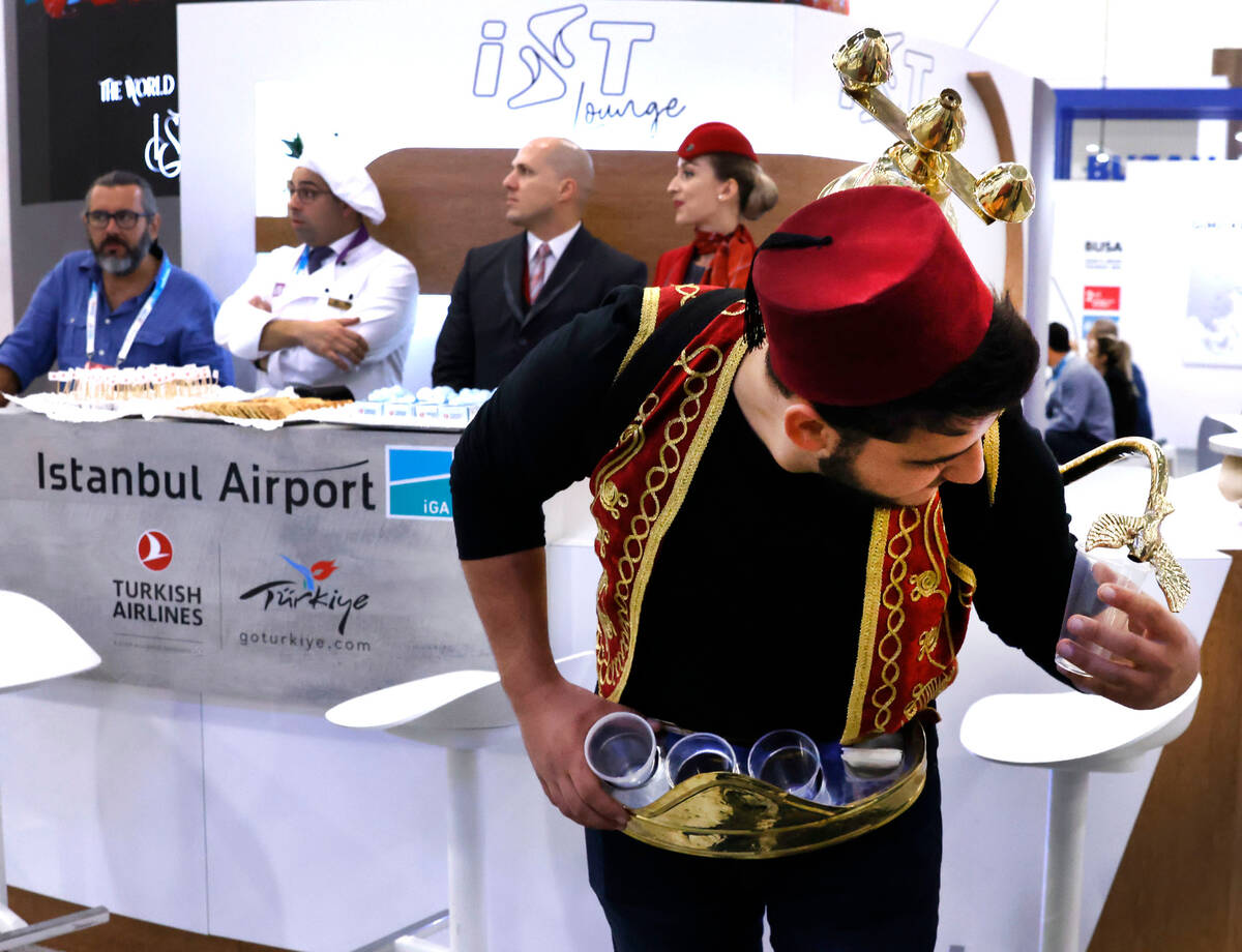 Abdul Alokla pours Turkish Sherbet, a natural homemade juice, at Istanbul Airport booth during ...