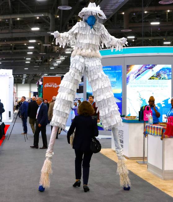 Alicia Casart, of Barcelona, Spain, walks under stilt dancer as she arrives at the 27th World R ...