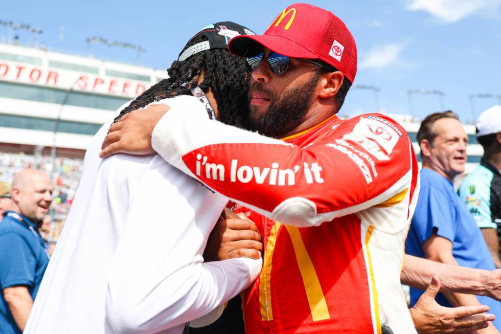 Honorary pace car driver Davante Adams of the Raiders, left, greets driver Bubba Wallace before ...