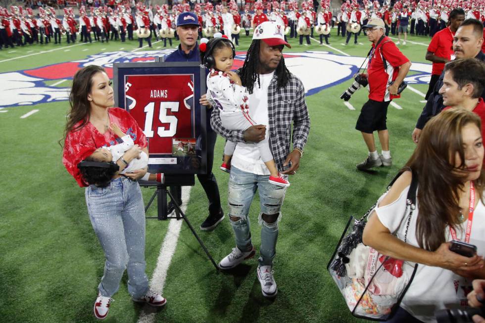 Las Vegas Raiders' Davante Adams, center, a former Fresno State player, has his jersey number r ...