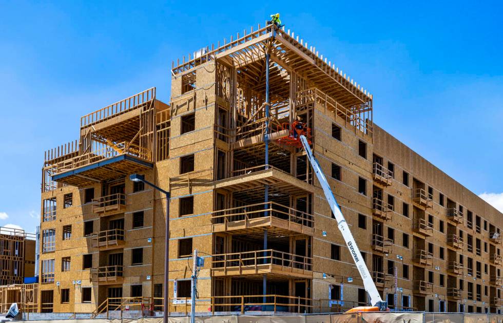 Construction continue on a new apartment building next to the existing Tanager apartment comple ...