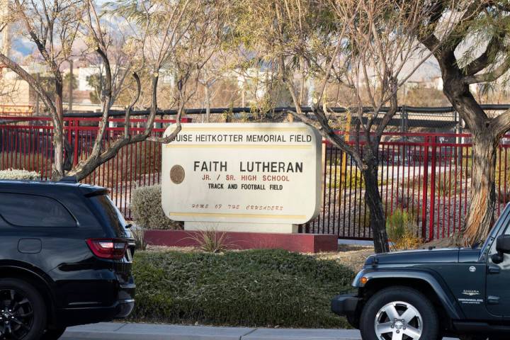Parents in their cars lined up to enter Faith Lutheran Middle School and High School to drop of ...
