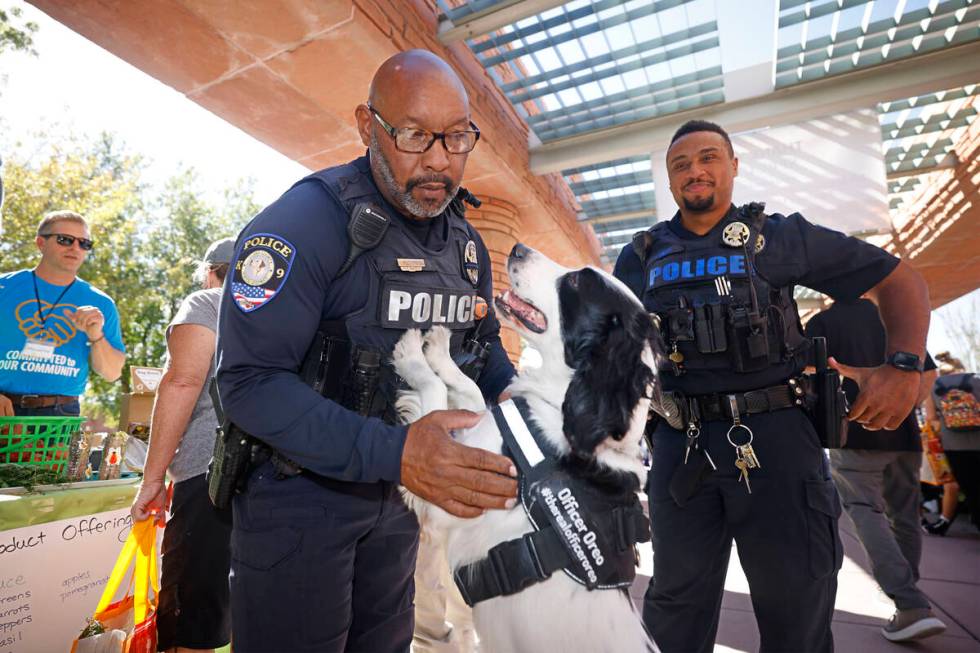 Clark County School District Police Department K-9 officer Anthony Cooke, left, plays with his ...