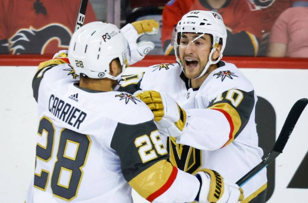 Vegas Golden Knights forward William Carrier, left, celebrates his goal against the Calgary Fla ...