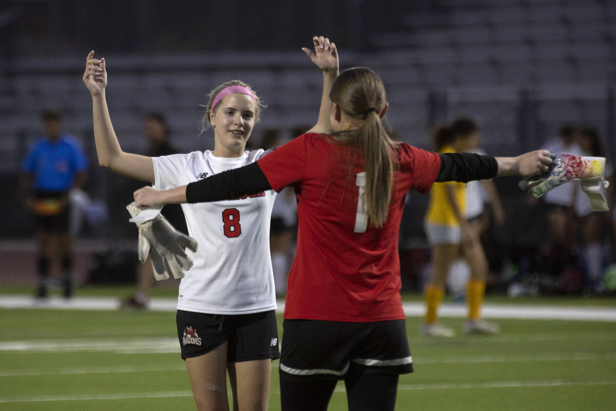 Doral Academy’s Abigail Woods (8) celebrates with her teammate Kenadie Mashore (1) after ...