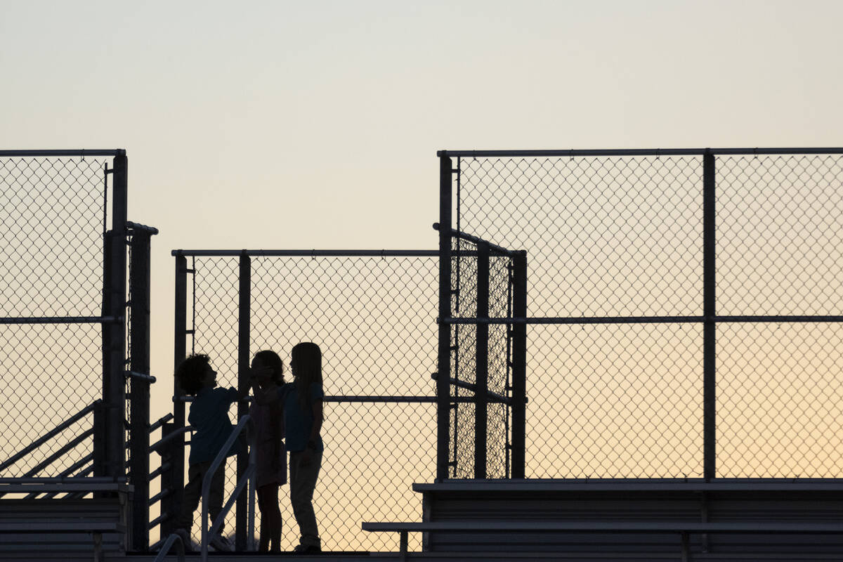 Young spectators play on the bleachers during a girls high school soccer game between Bonanza a ...