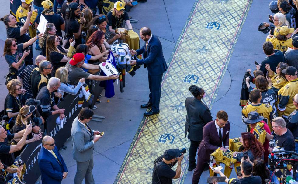 The Golden Knights Phil Kessel signs autographs as players and coaches walk the gold carpet at ...