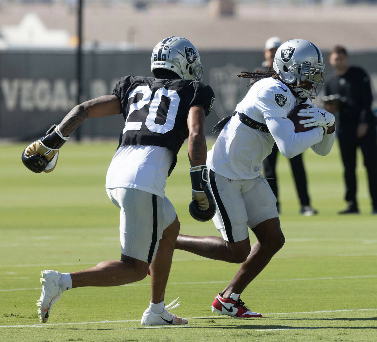 Raiders safety Isaiah Pola-Mao (20) pursues wide receiver Davante Adams (17) attempting to punc ...