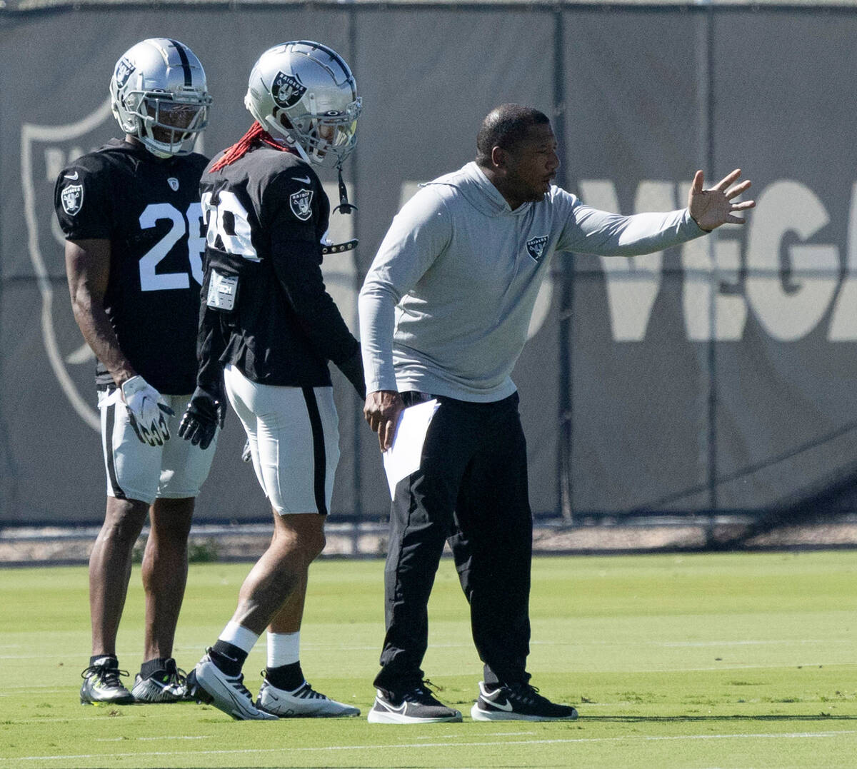 Raiders cornerbacks Anthony Averett (29) and Rock Ya-Sin (26) listen as secondary coach Jason S ...