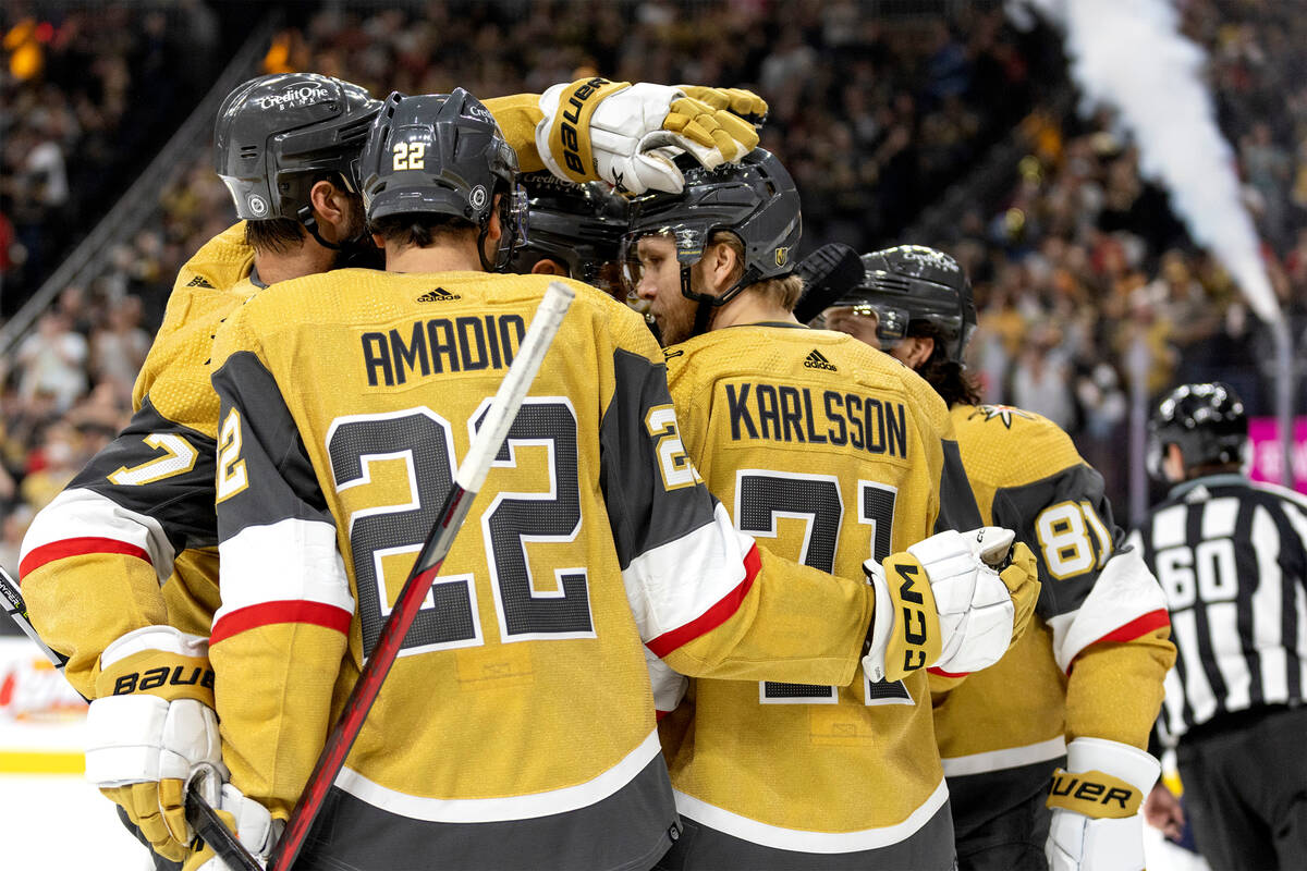 Golden Knights players congratulate center William Karlsson (71) after he scored a goal assiste ...