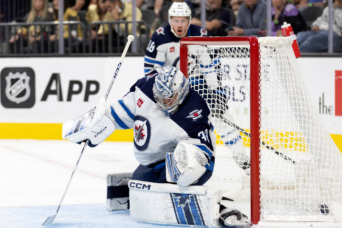 Jets goaltender David Rittich (33) misses the save on a goal shot by Golden Knights center Jack ...