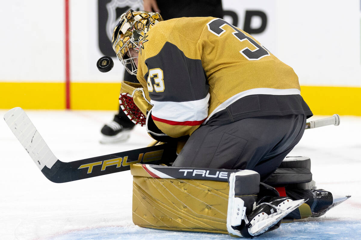 Golden Knights goaltender Adin Hill (33) saves the puck during the second period of an NHL hock ...