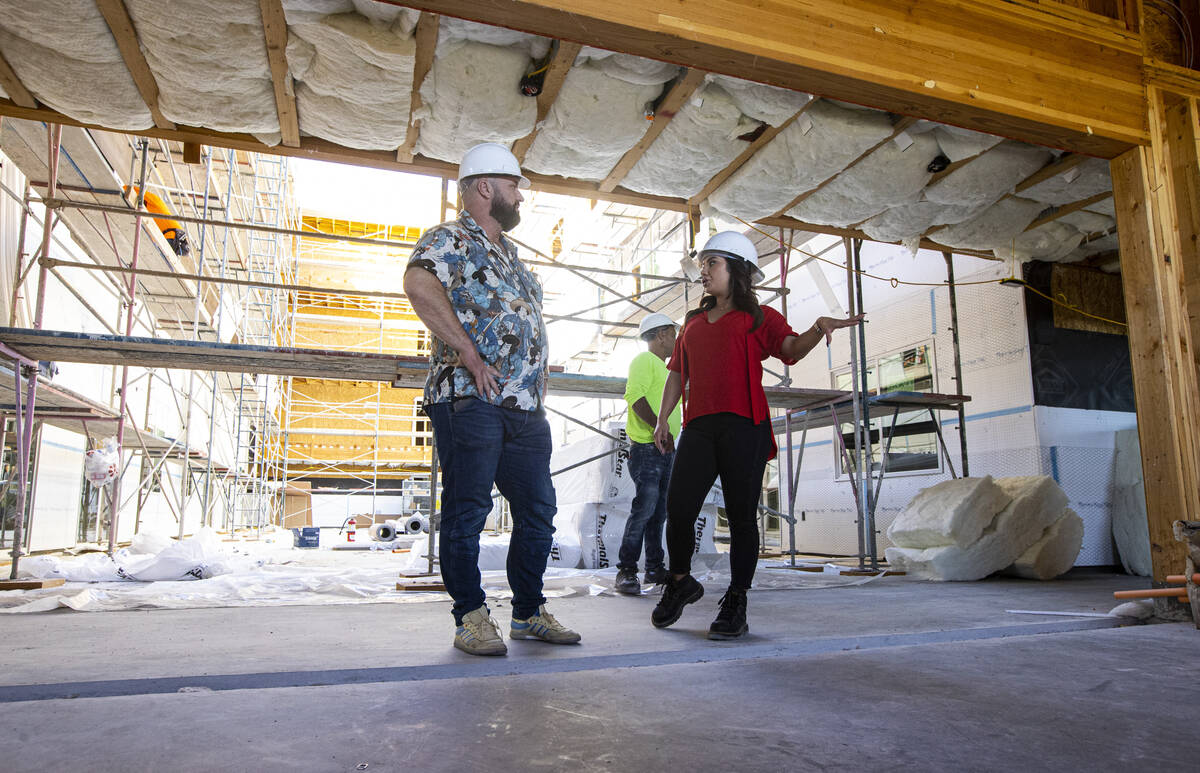 Tiffany Brown, property manager at ShareDOWNTOWN, right, gives a tour to a prospective tenant a ...