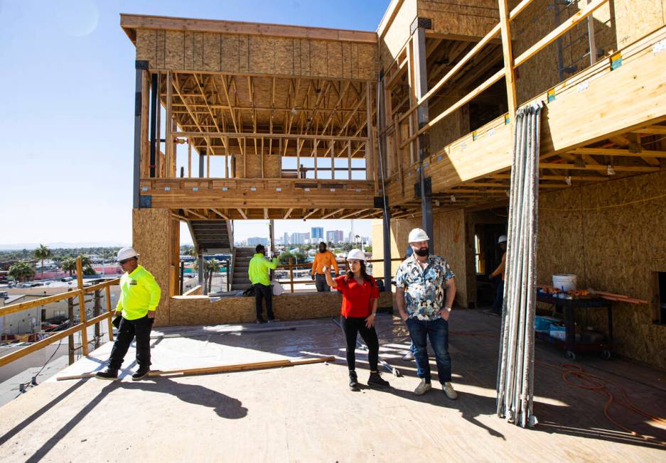 Tiffany Brown, property manager at ShareDOWNTOWN, right, in red, points out the views from the ...