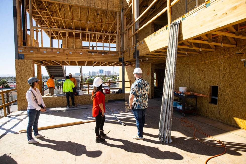 Tiffany Brown, property manager at ShareDOWNTOWN, right, in red, points out the views from the ...