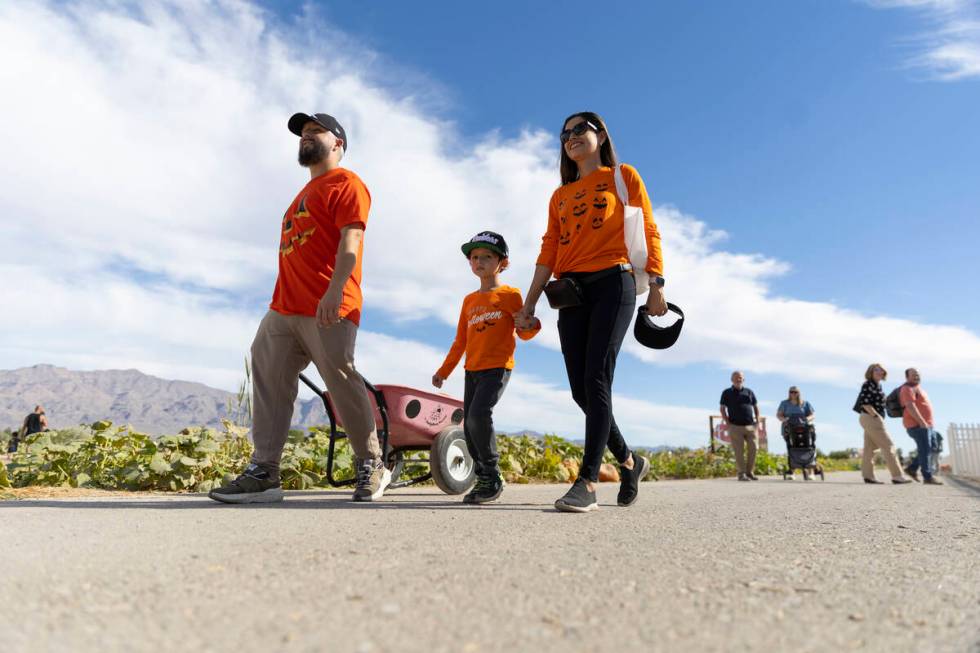 Jhobany Escalante, from left, with his son Owen, 4, and wife Carina, visit Gilcrease Orchard in ...
