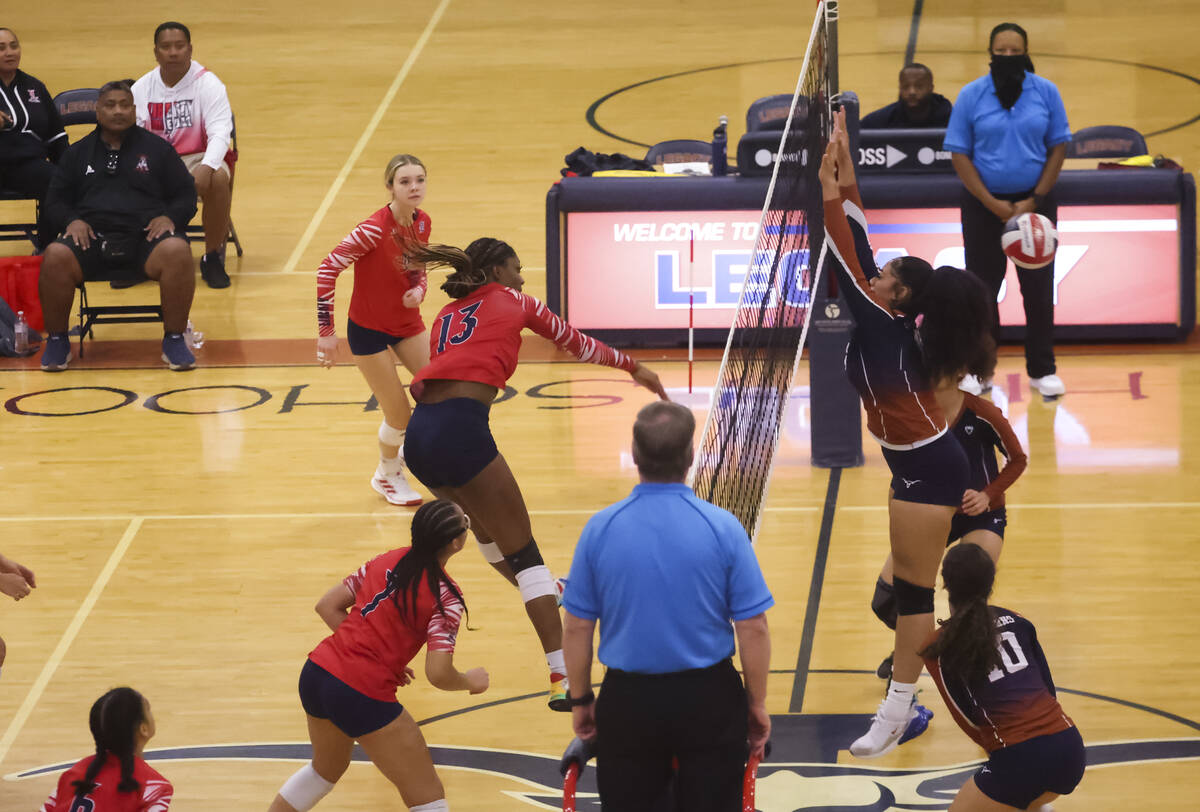 Liberty's AMAYA TOBIAS (13) sends the ball past Legacy defenders during a volleyball game at Le ...