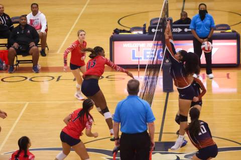 Liberty's AMAYA TOBIAS (13) sends the ball past Legacy defenders during a volleyball game at Le ...