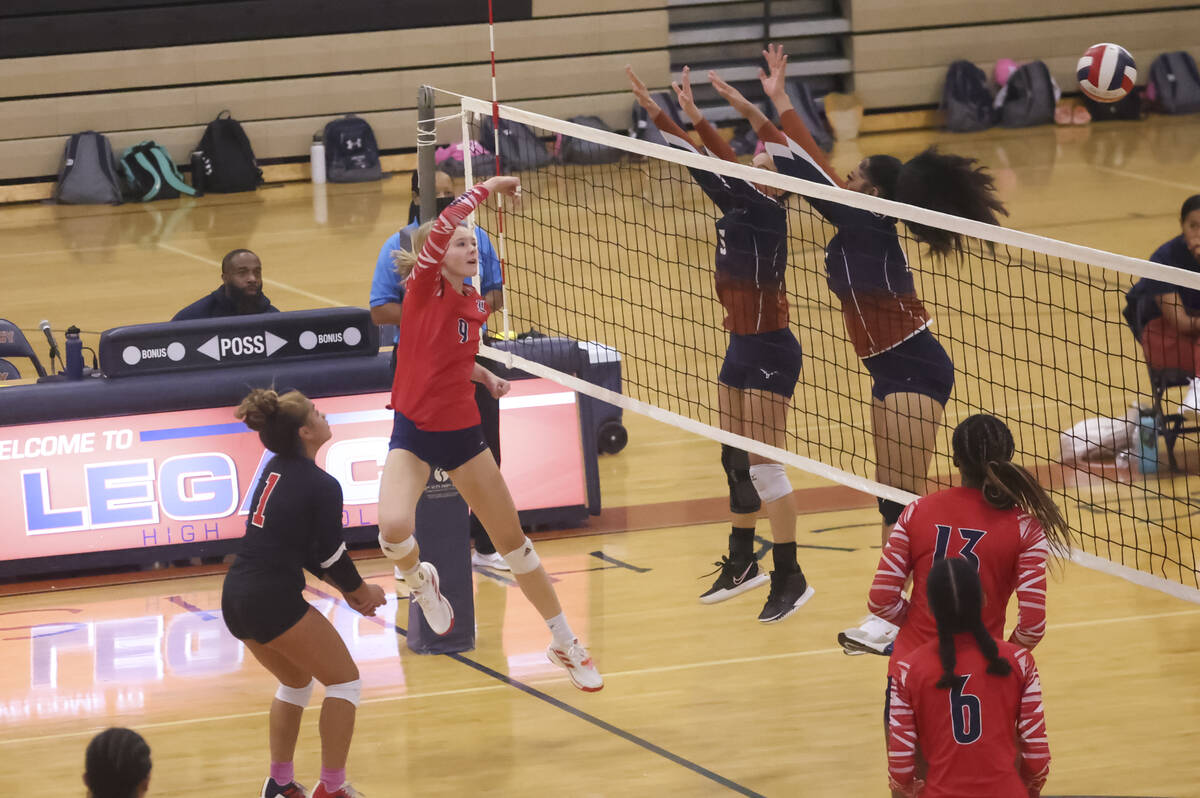 Liberty's Sydney Smith (9) sends the ball over the net past Legacy's Miy'Aja Diggs (5) and Siun ...