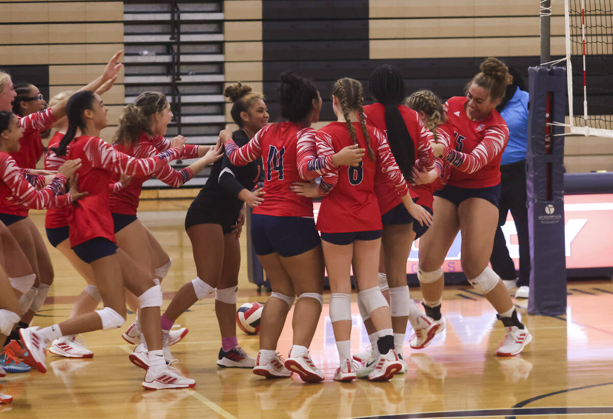 Liberty players celebrate after defeating Legacy in a volleyball game at Legacy High School on ...