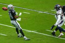 Raiders wide receiver Keelan Cole (84) looks back on a punt that bounces away as Denver Broncos ...