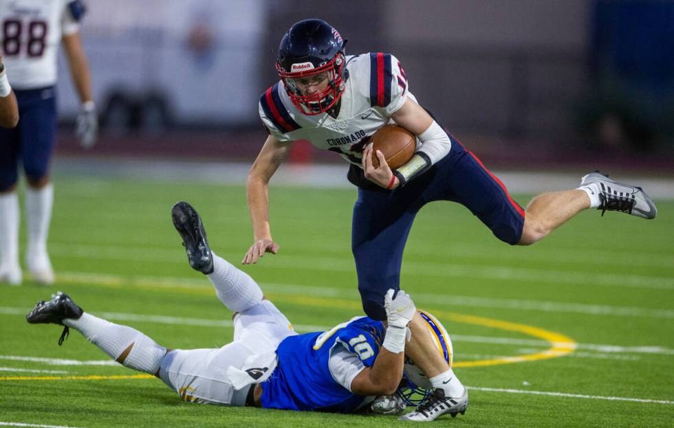 Coronado QB Aiden Krause (10) looks to break a tackle on a run over Sierra Vista LB Reese Pasio ...