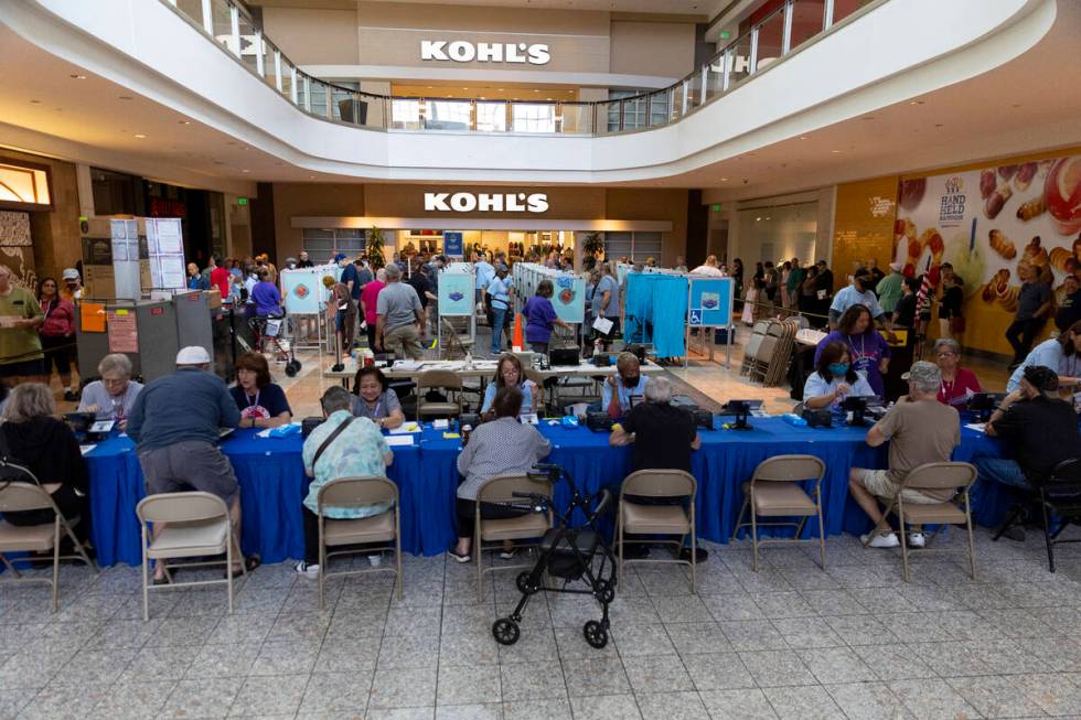 People visit the polling place inside of the Galleria at Sunset shopping mall in Henderson, Sat ...