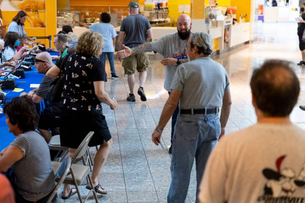 Poll worker Phil Hallond directs people at the polling place inside of the Galleria at Sunset s ...