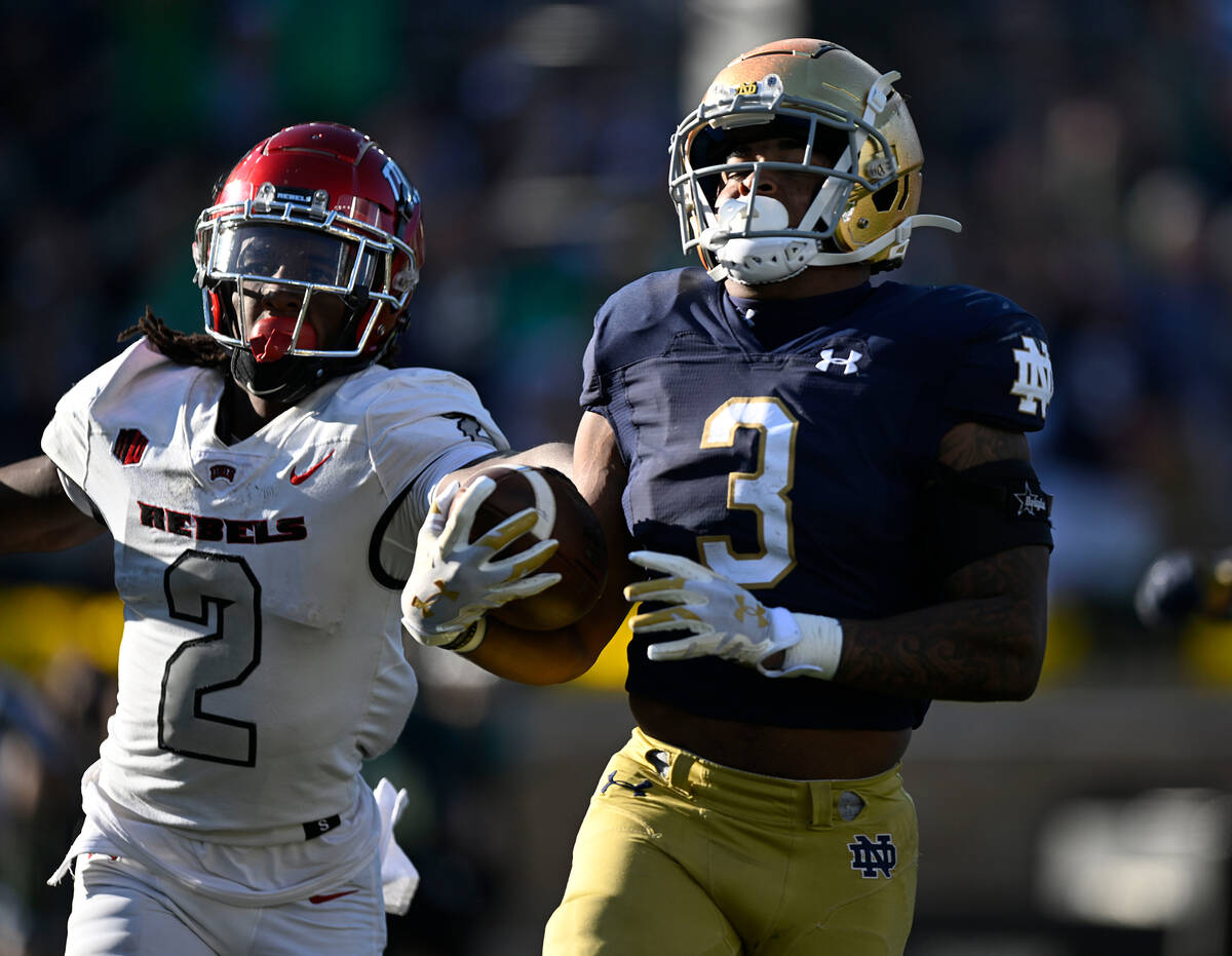 Notre Dame running back Logan Diggs (3) rush the ball past UNLV defensive back Nohl Williams (2 ...