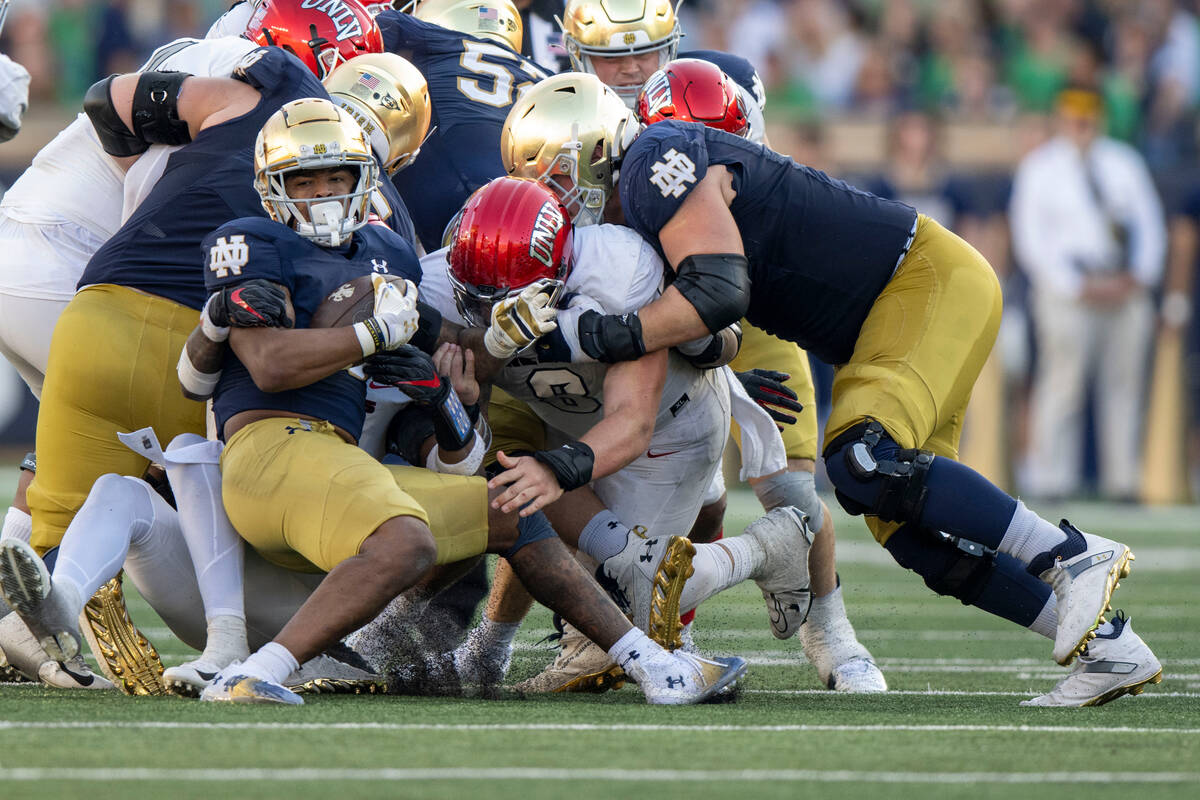 Notre Dame running back Logan Diggs (3) pushes against the pile during the second half of an NC ...