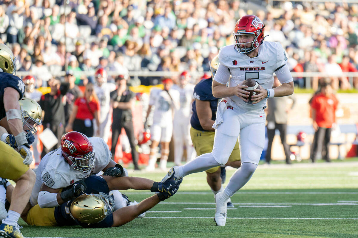 UNLV quarterback Harrison Bailey (5) evades tackle during the second half of an NCAA college fo ...