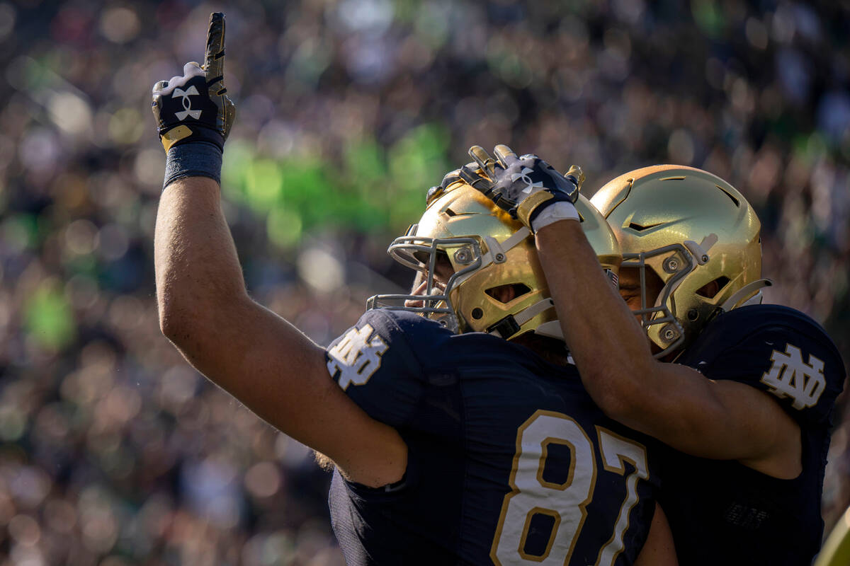 Notre Dame tight end Michael Mayer (87) celebrates a touchdown with wide receiver Braden Lenzy ...