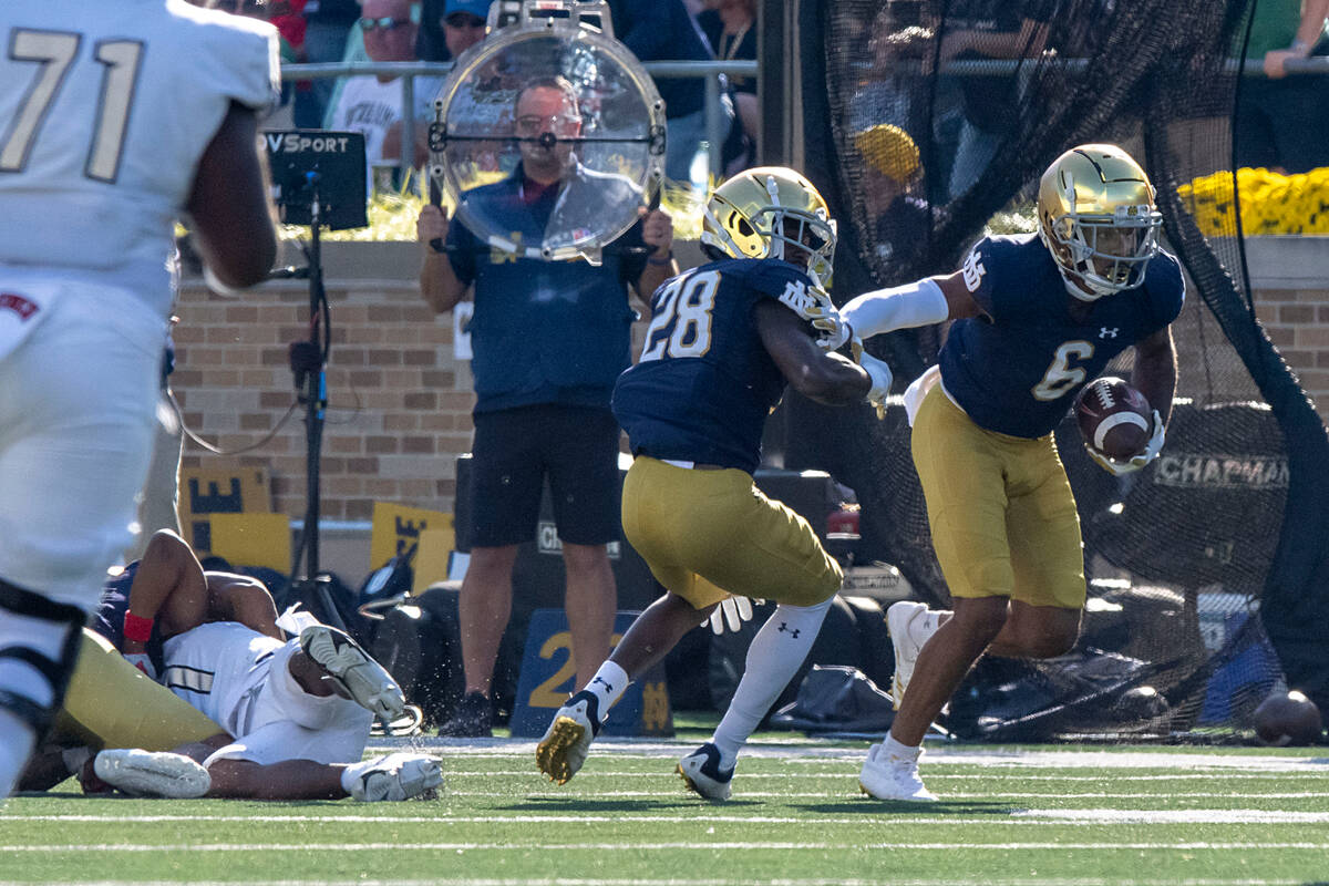 Notre Dame cornerback Clarence Lewis (6) picks up a fumble and runs down the field during the s ...