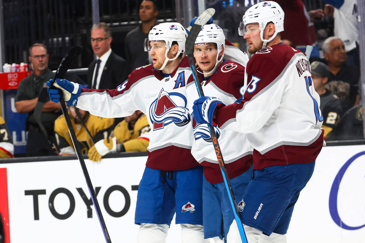 Colorado Avalanche center Nathan MacKinnon, left, celebrates his goal with left wing Artturi Le ...