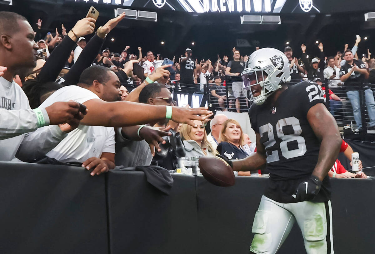 Raiders running back Josh Jacobs (28) celebrates his touchdown with fans during the second half ...