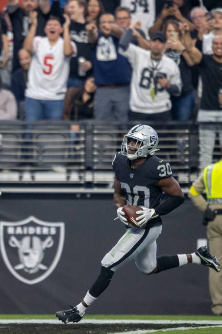 Raiders safety Duron Harmon (30) scores a touchdown after intercepting Houston Texans quarterba ...