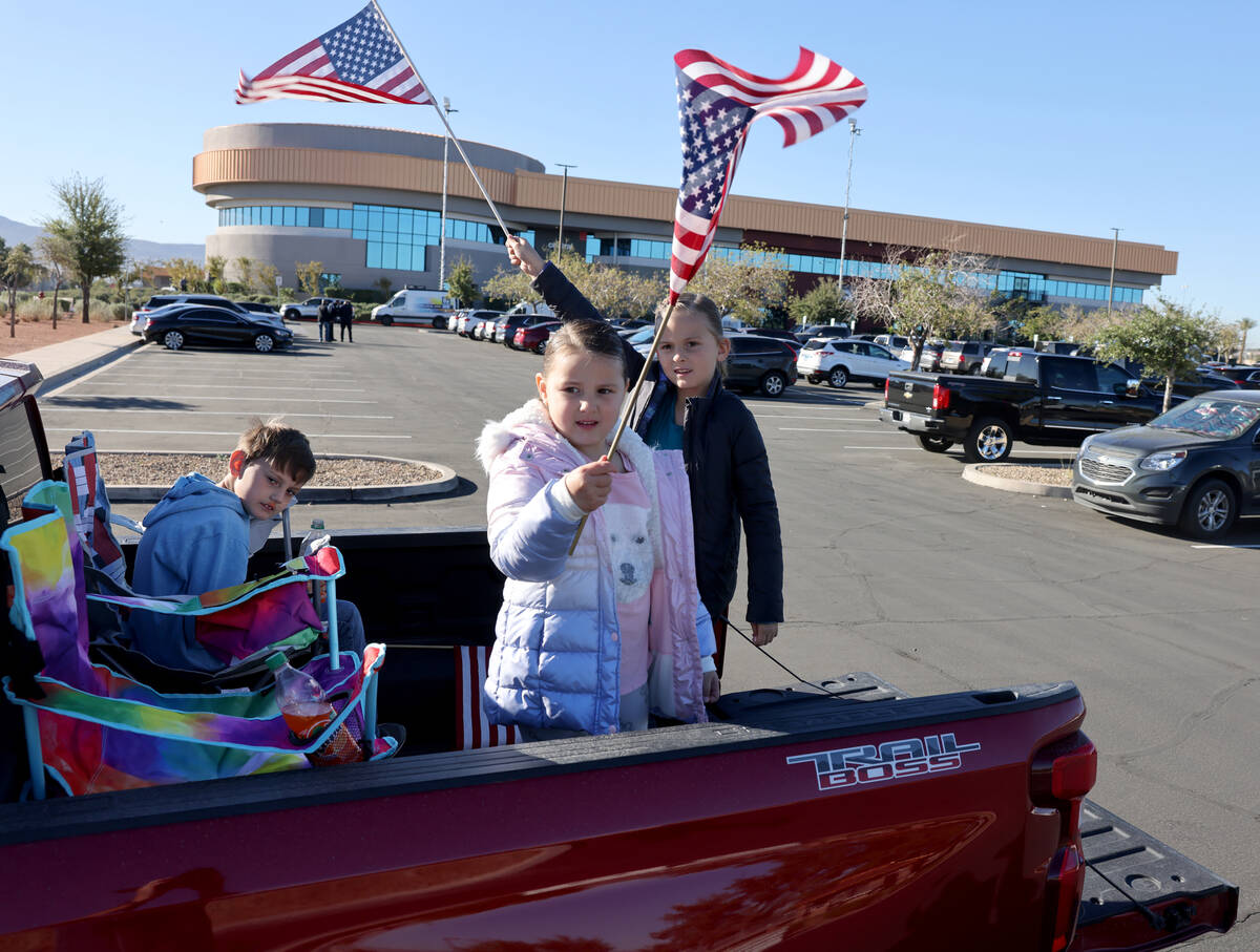 Siblings, from left, Kolten Ruiz, 8, Zoey Ruiz, 4, and Antonia Ruiz, 7, wave flags in the back ...