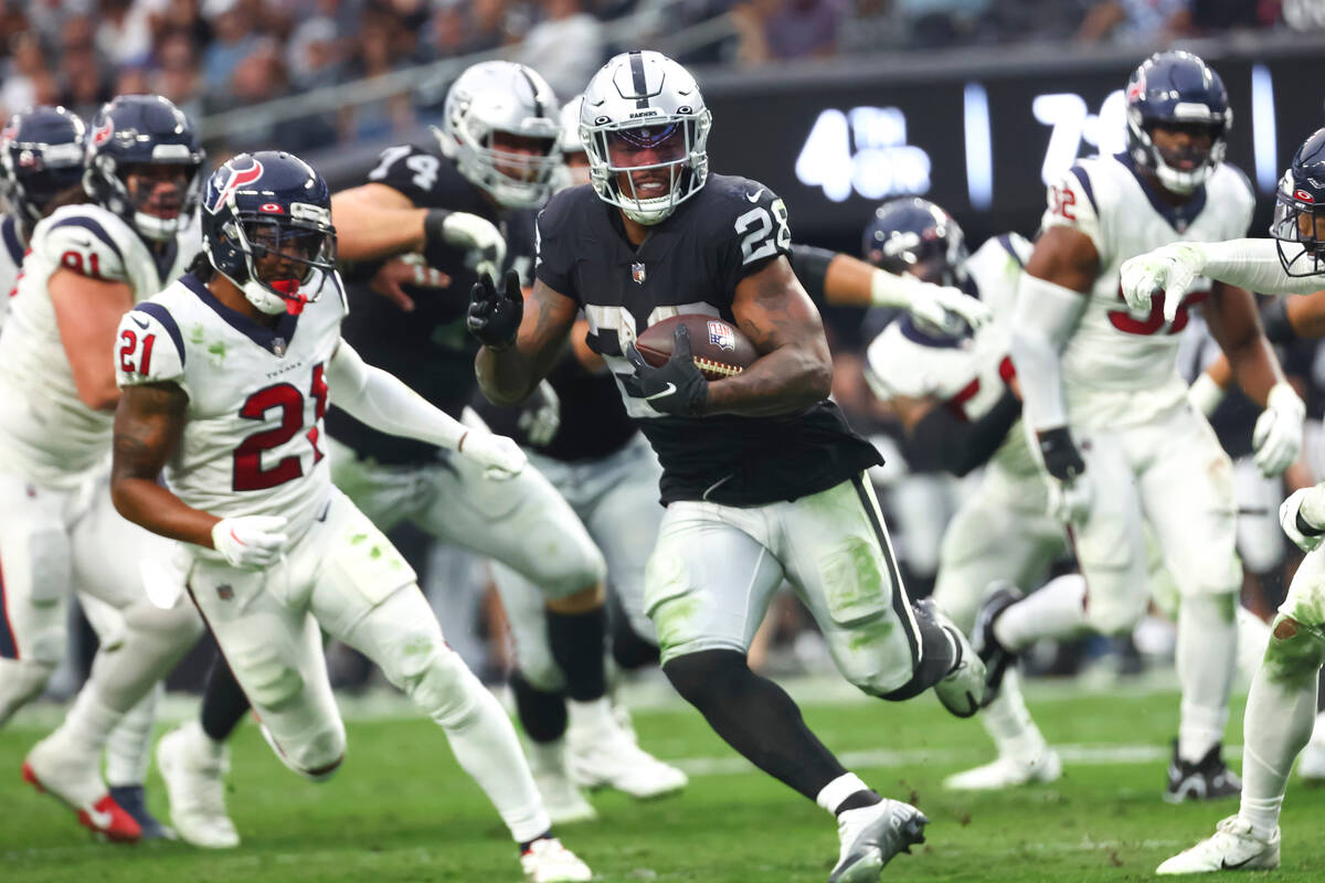 Raiders running back Josh Jacobs (28) runs the ball against the Houston Texans during the secon ...